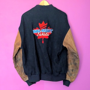 May include: A black and brown varsity jacket with a red maple leaf and the text "WAL-MART Canada" on the back.