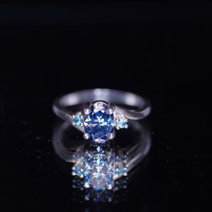 1.25 Carat Oval Cut True Blue Moissanite, with Natural London Blue Topaz Accents, 925 Sterling Silver Accent Ring