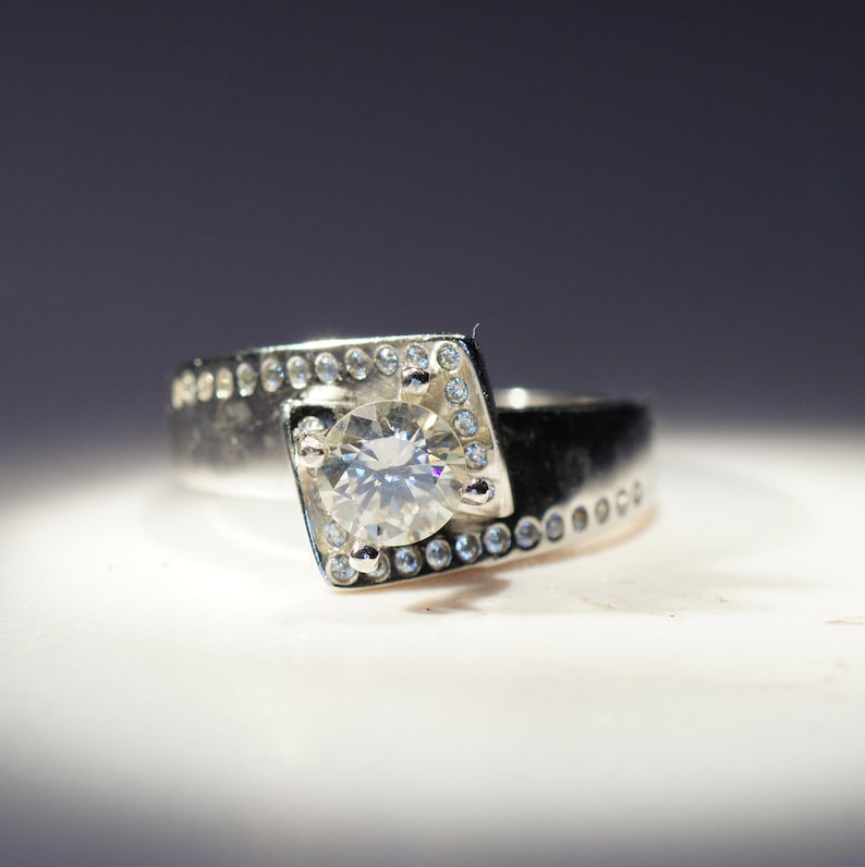 with bezel set cubic zirconia accents, 5.6mm.7 Carat Pure White Moissanite VVS1 in 925 Silver E-F Color Range