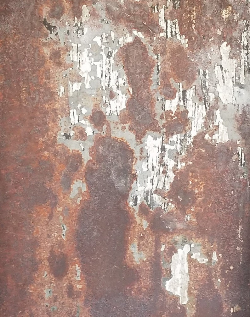 May include: A close-up of a rusty metal surface with peeling paint. The surface is a mix of brown, gray, and white. The paint is peeling in large patches, revealing the rusty metal underneath.
