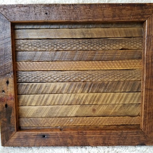 May include: A rustic wooden tray with a dark brown frame and a natural wood interior. The interior is made of multiple pieces of wood with different grain patterns, creating a unique and interesting design.