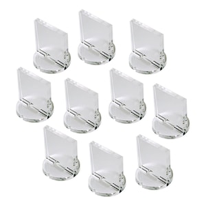 May include: Ten clear acrylic display stands for miniature figures or other small objects. Each stand has a round base and a square platform.