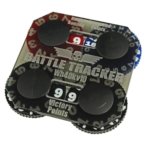 May include: A clear plastic battle tracker with black dials and a skull logo. The dials are labeled "Battle Rounds", "Command Points", and "Victory Points". The tracker is labeled "BATTLE TRACKER Wh40Kv10".