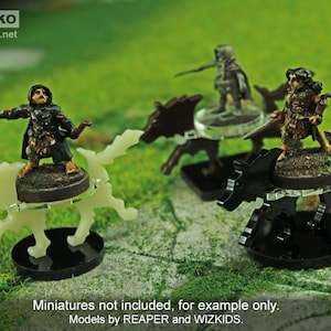 May include: Four clear plastic miniature wolf bases with black bases. The bases are designed to hold miniature figures. The bases are for use with tabletop games.