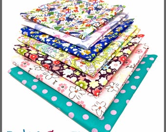 May include: A stack of ten-inch by ten-inch (25.4 cm x 25.4 cm) 100% cotton fabric squares in various floral and polka dot patterns. The color palette includes blue, pink, yellow, and green. The text "PBC7070FS / 10" x 10" 100% Cotton" is visible.
