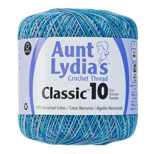 May include: A ball of Aunt Lydia's Classic 10 crochet thread. The thread is a blend of blue, teal, and lavender. The label reads "Aunt Lydia's Crochet Thread Classic 10" and "100% Mercerized Cotton".