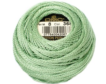 May include: A green ball of DMC Perle 8 cotton embroidery thread, labeled with the DMC logo and the color number 368.