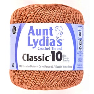 May include: A ball of Aunt Lydia's Classic 10 crochet thread in a terracotta color. The label reads "100% Mercerized Cotton/Coton Mercerisé/Algodón Mercerizado".