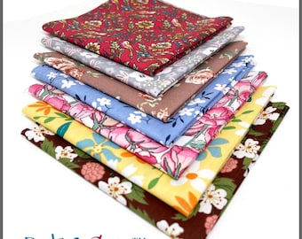 May include: A stack of ten-inch by ten-inch floral cotton fabric squares in various colors. The fabrics feature patterns of flowers and leaves in shades of red, blue, yellow, and brown. The text "PBC3030FS-10"X 10" 100% Cotton" is visible.