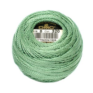 May include: A ball of DMC Perle cotton thread in a soft, muted green color, Col. 320. The label indicates it's made in France. The thread is tightly wound, showing the texture of the individual strands. Ideal for embroidery and other needlecraft projects.