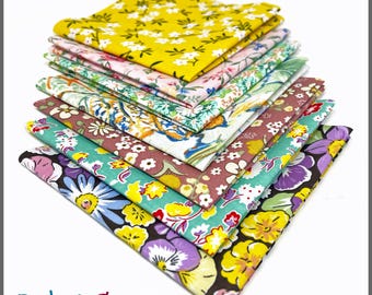 May include: A stack of ten 10" x 10" cotton fabric squares in various floral patterns. The fabrics feature a range of colors, including yellow, pink, green, and purple, with white floral designs. The text "PBC6060FS / 10" x 10" 100% Cotton" is visible.