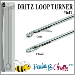 May include: A silver Dritz Loop Turner tool, shown in both open and closed positions. The tool is used for turning loops in knitting and crocheting. The packaging includes the text "Dritz Loop Turner #647".