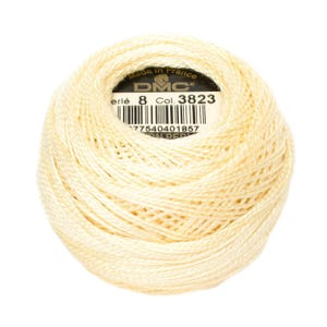 May include: A ball of DMC embroidery floss in color 3823, a pale yellow. The label reads "DMC" and "Col. 3823" with a barcode and "Made in France".
