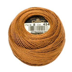 May include: A brown ball of DMC Perle 8 cotton embroidery thread, size 434. The label reads "DMC Perle 8 Col. 434" and has a barcode.