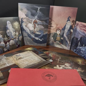 May include: A set of illustrated cards featuring a wizard with a long white beard and a young person. The cards are part of a larger set that includes a book and an envelope. The cards are printed on high-quality cardstock and are perfect for sending a special message.