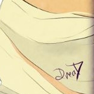 May include: A close-up of a light yellow fabric with the word "Dream" written in black ink.