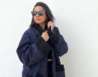 One-of-a-kind overdyed Banjara tapestry coat with black shearling trim, cotton lining, and intricate tribal embroidery — wearable boho art