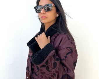 One-of-a-kind overdyed Banjara tapestry coat with black shearling trim, cotton lining, and intricate tribal embroidery — wearable boho art