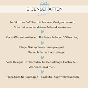 May include: A white background with blue hearts and black text that reads "EIGENSCHAFTEN". The text below describes the features of a glass jar with a wooden lid. The features include: "Perfect for filling with chocolates, gift certificates, or small tokens of appreciation", "Clear glass with a rustic wooden lid and silicone ring", "Care: Glass is dishwasher safe, lid should be hand washed", "Many designs in the shop: Ideal for birthdays, weddings, Christmas & more", "Sustainable natural product - plastic-free & environmentally friendly".