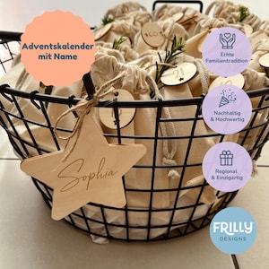 May include: A black wire basket filled with numerous small beige fabric drawstring pouches. Each pouch features a round wooden tag with a number and a sprig of greenery. A large wooden star tag with the name Sophia is tied to the front.
