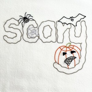 May include: A white fabric featuring black embroidery that spells the word Scary. The design includes a black spider on the letter S, a spiderweb inside the letter C, a black bat above the letter R, and an orange pumpkin with a face on the letter Y.