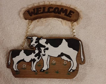 Cow wood welcome sign