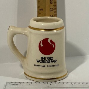 The 1982 World&#39;s Fair Knoxville TN Commemorative Collectible Gold Trim Shot Glass With Handle Small Mug Collect