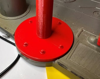 May include: A red plastic base with a blue and white plastic pole attached. The base has six small screws around the edge.