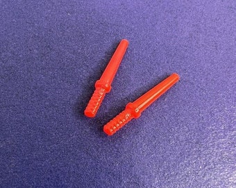 May include: Two red plastic toy swords with a textured surface.