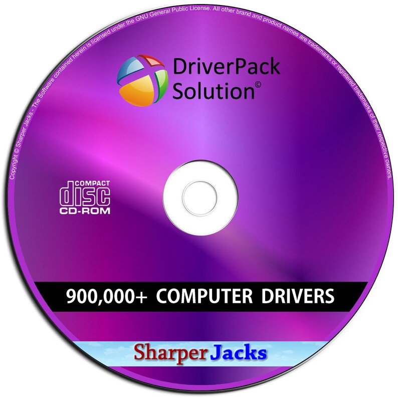 May include: A purple CD-ROM featuring "DriverPack Solution" and "900,000+ COMPUTER DRIVERS." The disc has a colourful logo and the words "COMPACT disc CD-ROM." The bottom of the disc says "Sharper Jacks."