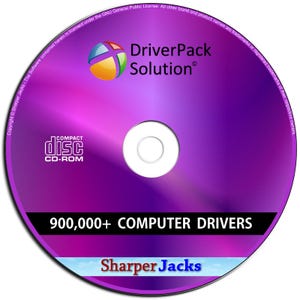 May include: A purple CD-ROM featuring the text "DriverPack Solution" and "900,000+ COMPUTER DRIVERS." The disc has a colourful logo and the words "COMPACT disc CD-ROM." The bottom of the disc says "Sharper Jacks."
