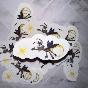 May include: A pile of white cloud-shaped stickers with a cartoon firefly on each. The fireflies are yellow and brown with black eyes and blue wings. Each firefly is holding a small yellow star.