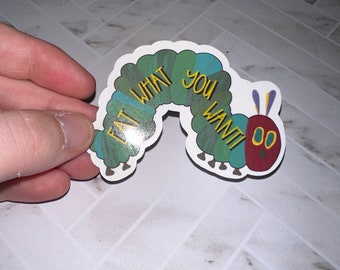 May include: A green and blue caterpillar sticker with the text "Eat What You Want!" in yellow letters. The caterpillar has red feet and two yellow antennas.