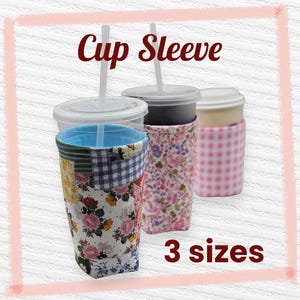 May include: Image of three beverage cups with straws, each in a different patterned cup sleeve. The sleeves feature floral, gingham, and patchwork designs. Text reads "Cup Sleeve" and "3 sizes".