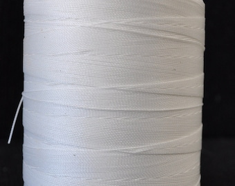 May include: A spool of white thread wound around a black plastic bobbin.
