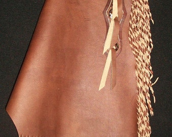 May include: Brown leather chaps with a fringe trim. The chaps have a belt loop and a decorative stitching detail.