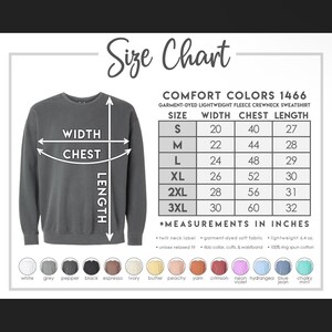 May include: Size chart for a garment-dyed lightweight fleece crewneck sweatshirt in Comfort Colors 1466. The chart shows measurements in inches for width, chest, and length for sizes S, M, L, XL, 2XL, and 3XL. The chart also includes information about the fabric, which is 100% ring spun cotton.