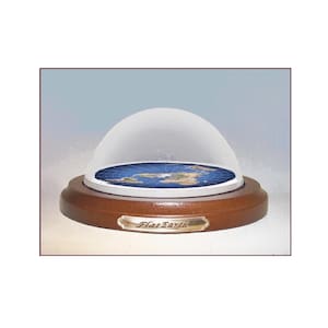 May include: A circular, flat map of the Earth featuring blue oceans and multicolored continents, enclosed within a clear glass dome. The display rests on a round, dark brown wooden base with a metallic plaque engraved with the text Flat Earth.