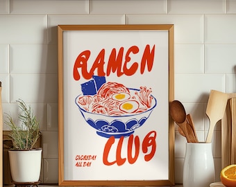 May include: A framed print with a red and blue illustration of a bowl of ramen noodles. The text "Ramen Club" is written in red and blue letters. The text "Everyday All Day" is written in blue letters below the bowl of ramen.