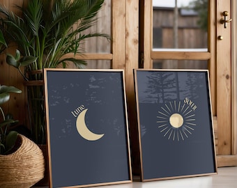 May include: Two framed prints with a dark blue background and gold accents. The left print features a crescent moon with the word "lune" above it. The right print features a sun with rays and the word "soleil" above it.