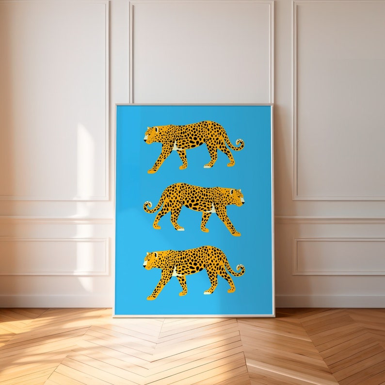 May include: Three stylised leopards walking in a row on a bright blue background. The leopards are orange and black with a spotted pattern.