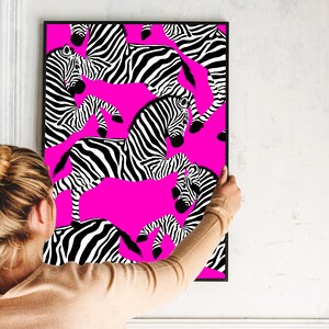 May include: A framed print with a pink background and a black and white zebra pattern. The zebra pattern is repeated throughout the print.