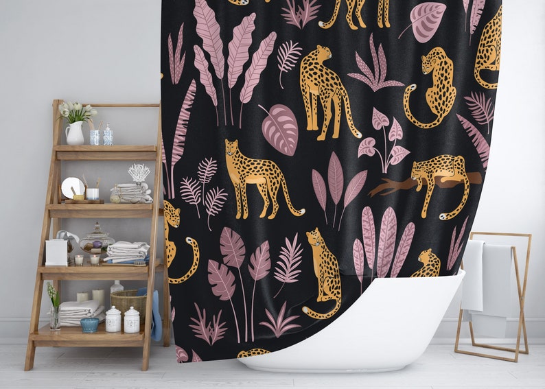 May include: A black shower curtain with a repeating pattern of pink leaves and orange leopards. The leopards are in various poses, some standing, some sitting, and some walking.