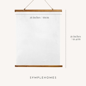 May include: A white poster with wooden hangers, 26 inches wide and 36 inches long. The poster is suspended by a natural rope. The brand name, SYMPLEHOMES, is printed at the bottom.