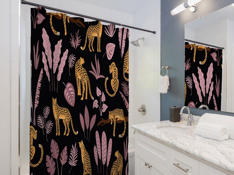 May include: A black shower curtain with a repeating pattern of pink and green leaves, and yellow leopards.