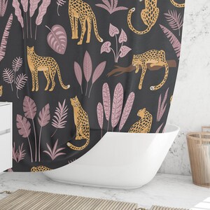 May include: A black shower curtain with a repeating pattern of pink leaves and orange leopards. The leopards are in various poses, including standing, sitting, and lying down.