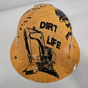 May include: A brown hard hat with a black excavator graphic and the text "Dirt Life".