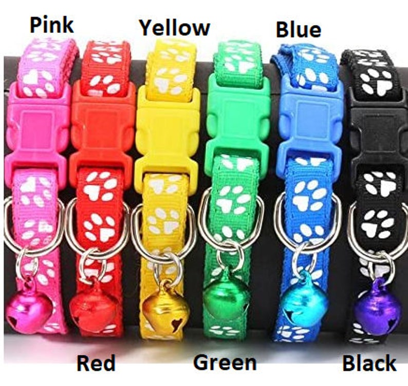 May include: A set of eight colourful cat collars with paw print designs and a bell. The collars are available in pink, red, yellow, green, blue, and black.
