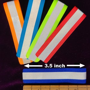 K&ouml;nnte beinhalten: F&uuml;nf reflektierende Stoffstreifen in verschiedenen Farben: Orange, Blau, Gr&uuml;n, Rot und Blau. Die Streifen sind 8,9 cm lang und haben einen wei&szlig;en reflektierenden Streifen in der Mitte.
