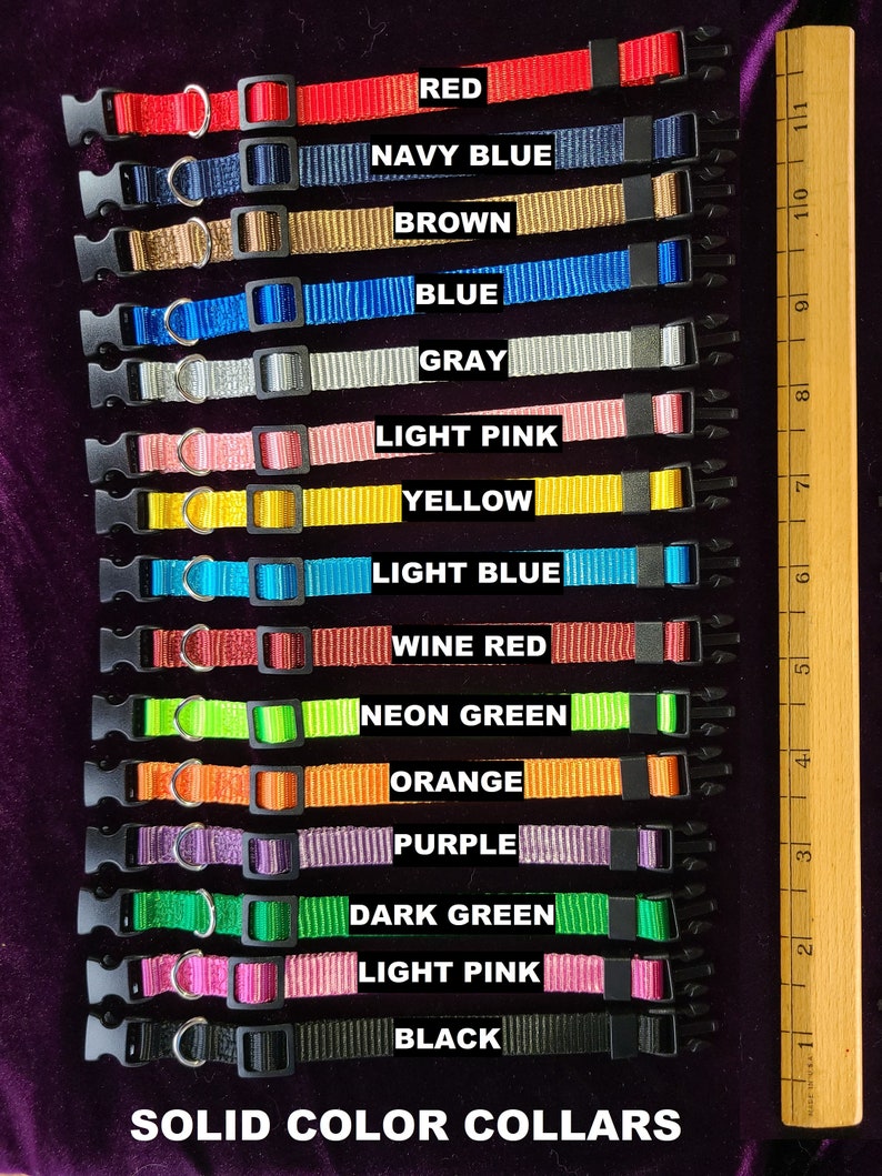 May include: A set of 15 solid colour dog collars in various colours, including red, navy blue, brown, blue, grey, light pink, yellow, light blue, wine red, neon green, orange, purple, dark green, light pink, and black. The collars are arranged vertically with the colour names printed below each collar. The text "SOLID COLOR COLLARS" is printed at the bottom of the image.